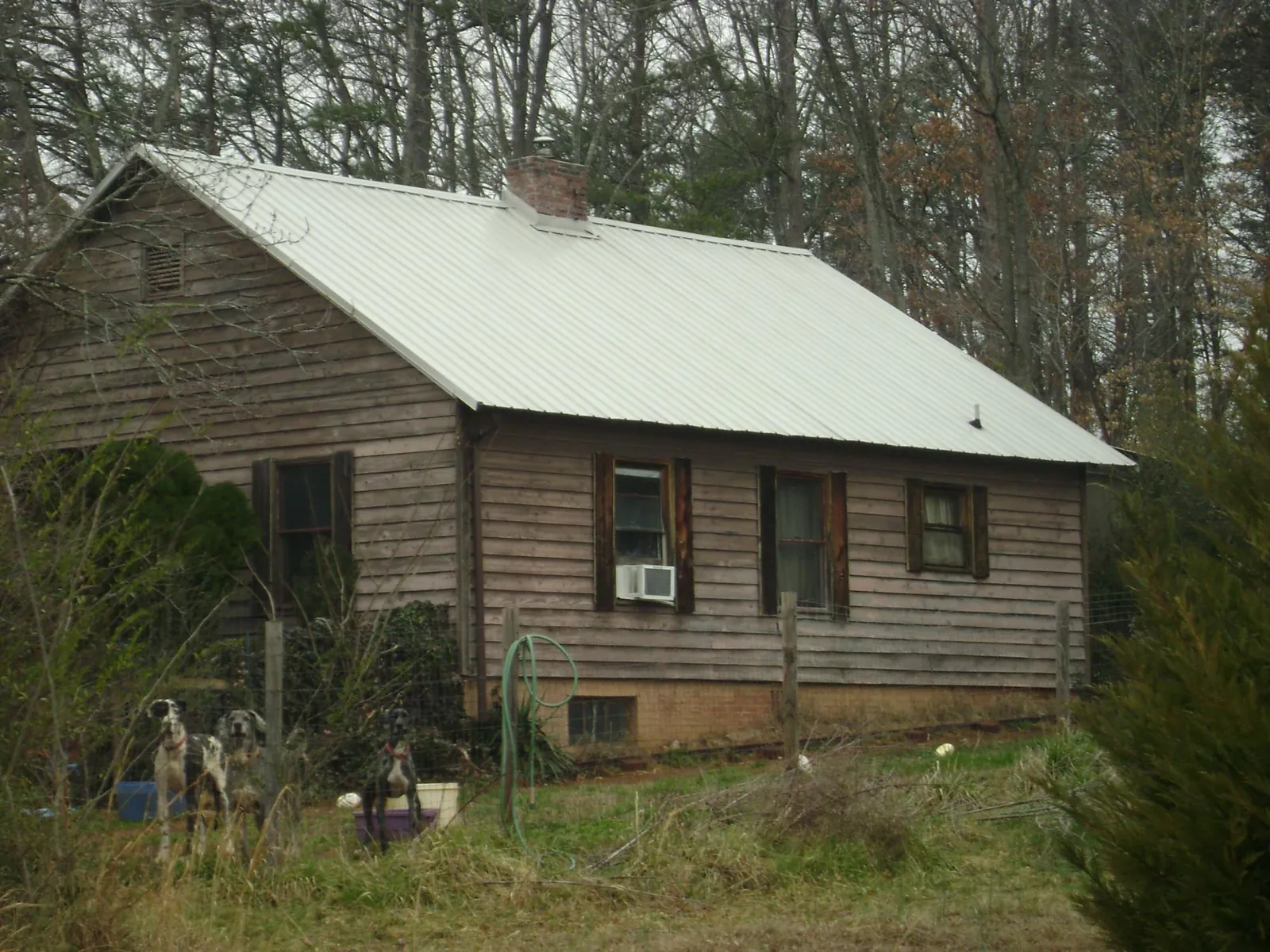 White metal roof on an old wood sided farmhouse, from a Metal Roof Installation job in Radcliff